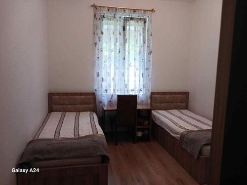 a small room with two beds and a window at Private family house in K'obulet'i