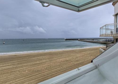 - une vue sur la plage depuis le balcon d'une maison dans l'établissement Appartement vue mer, Centre-ville & plage, à Quiberon