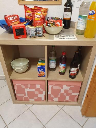 a wooden shelf with food and drinks on it at Privatzimmer mit Balkon im schönen Allgäu in Stetten