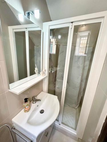 a white bathroom with a sink and a shower at La Casa del Sole in Corleone