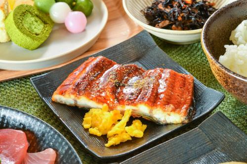 a plate of food with salmon and vegetables on a table at Sanco Inn Shizuoka Kitaguchi in Shizuoka