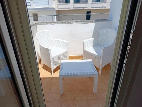 a room with two chairs and a table on a balcony at La Tartana in Castro di Lecce