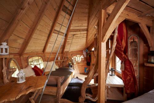 a tree house with a swing in a room at Cabanes de la Grande Noe in Les Épasses