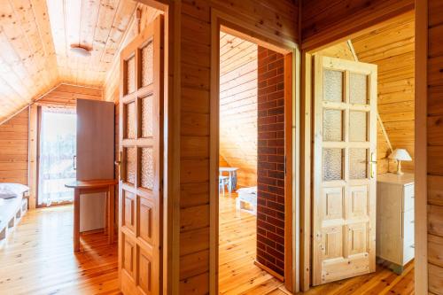 a room with two doors and a brick wall at Korsarz in Rusinowo