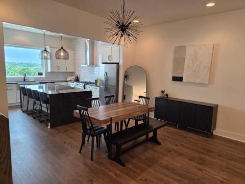 a kitchen and dining room with a wooden table and chairs at Nashville Riverfront Bliss in Nashville