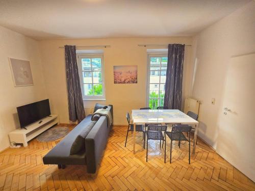 a living room with a couch and a table at City Heart Apartment Innsbruck in Innsbruck