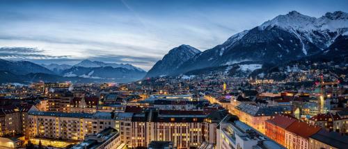 a view of a city with mountains in the background at City Heart Apartment Innsbruck in Innsbruck
