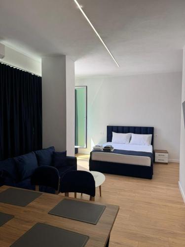 a living room with a bed and a couch at Arber Premium Apartment in Durrës