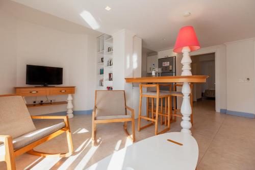 a living room with a table and a red lamp at Kalkan Suites Hotel in Kalkan