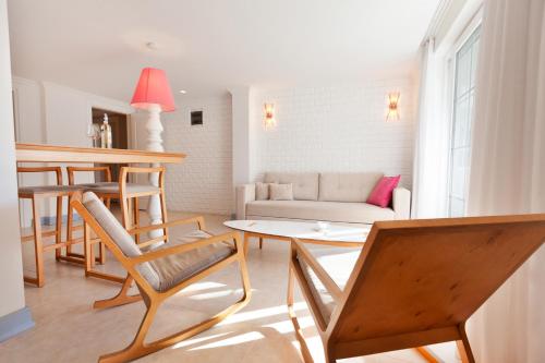 a living room with a couch and a table at Kalkan Suites Hotel in Kalkan