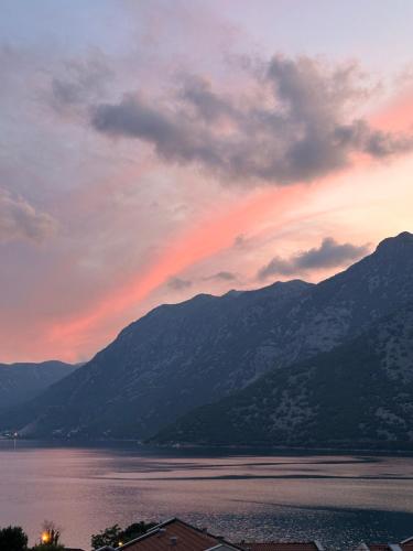 a rainbow in the sky over a body of water at Apartman Nina2 in Risan