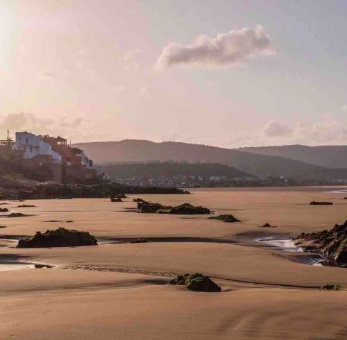 a view of the beach at sunset at Valley House Imi Ouaddar in Imi Ouaddar