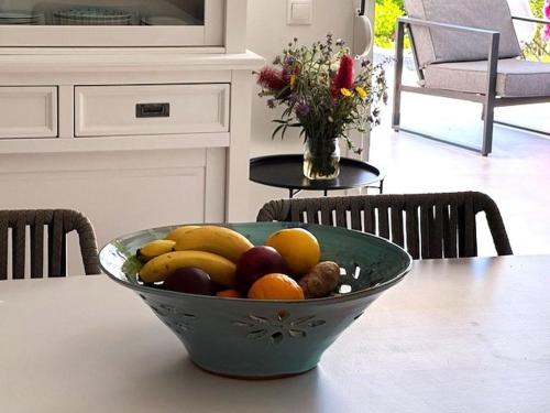 a bowl of fruit on a table in a kitchen at Villa Athina in Pangalochori