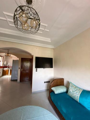 a living room with a couch and a flat screen tv at Valley House Imi Ouaddar in Imi Ouaddar