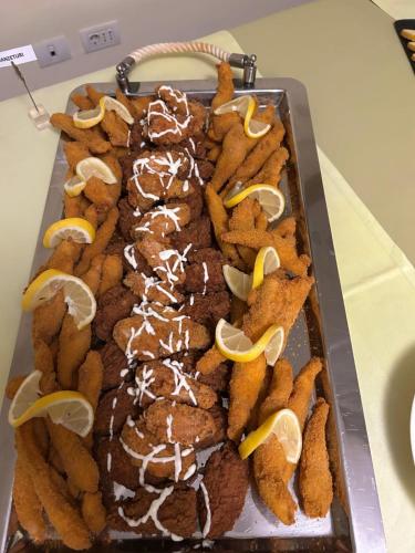 a tray of desserts with lemon slices on top at Hotel Carpați in Predeal