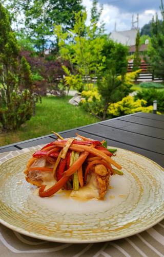 a plate of food sitting on a table at Hotel Carpați in Predeal