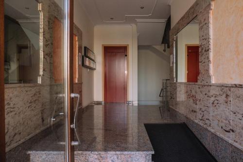 a bathroom with a walk in shower and a glass door at Calma y relax cerca del mar by CABANA Rentals in Ribeira