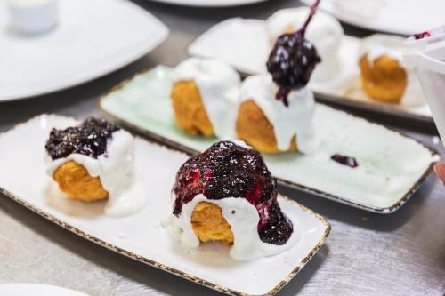 three plates with desserts on them on a table at Hotel Carpați in Predeal