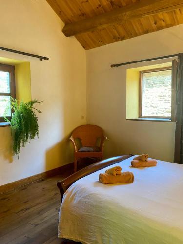 a bedroom with a bed with two towels on it at Le Refuge de Castagnols in Vialas