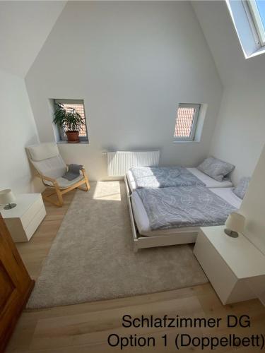 a bedroom with a bed and a chair at Michelles FeWo in Uttenweiler