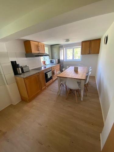 a kitchen with a table and chairs in a room at Michelles FeWo in Uttenweiler