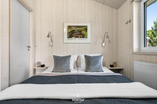 a bedroom with a large bed with two pillows at Ferienhaus Fernblick - Sankt Andreasberg im Harz in Sankt Andreasberg