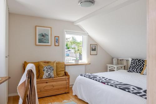 a bedroom with a bed and a window at Family Home - Coastal Calmness in Stockevik in Skärhamn