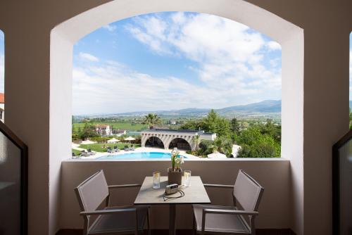 a view from the balcony of a villa with a table and chairs at Heaven Hotel Thessaloniki Airport in Néon Rýsion