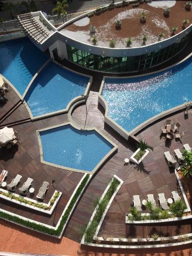 an overhead view of two swimming pools in a resort at Fortaleza Beach Class Apartments Tower 2 in Fortaleza