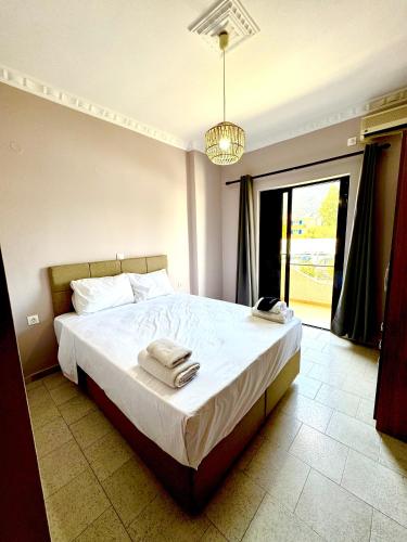 a bedroom with a large bed with towels on it at AMMOS FAMILY APARTMENTS in Vasiliki