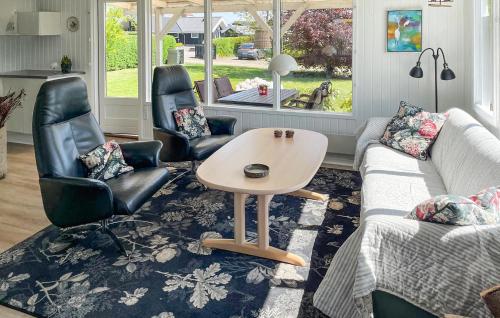 a living room with a couch and chairs and a table at Lurifax in Hejls
