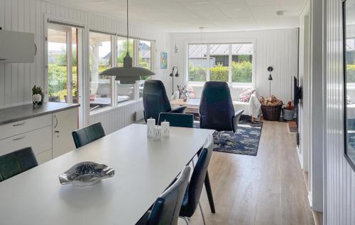 a kitchen and living room with a table and chairs at Lurifax in Hejls