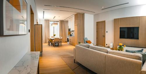 a living room with a couch and a television in it at First Grand Hotel in Dammam