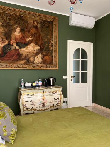 a bedroom with a painting on the wall and a bed at Joy19 B&B in Albissola Marina