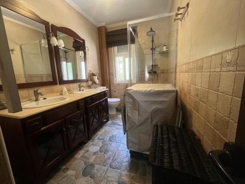 a bathroom with a sink and a toilet and a mirror at PINO BEACH in Punta Umbría