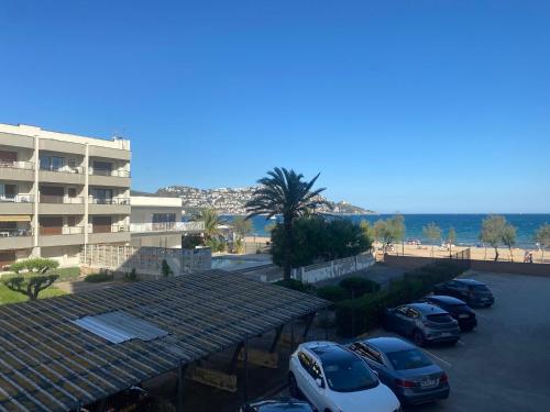 un gruppo di auto parcheggiate in un parcheggio accanto a un edificio di Miramar 14A a Roses