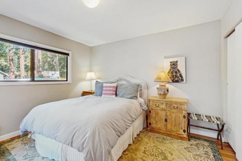 a bedroom with a bed and a window at Casual and Cute Cabin Near the Lake in Tahoe Vista