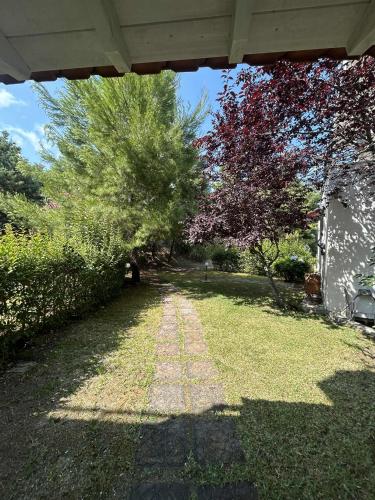 a yard with a brick path in the grass at Villa Georgia Poseidi in Kalandra