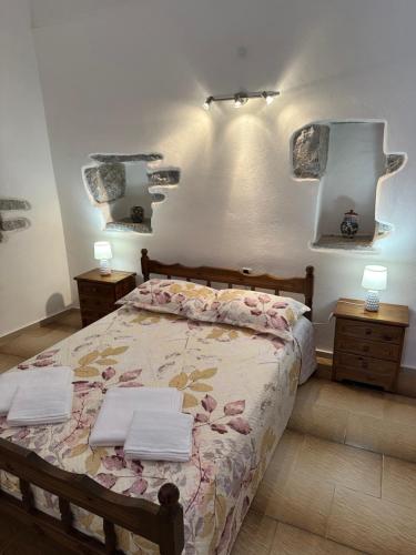 a bedroom with a bed with two towels on it at Katsi Traditional & Medieval House in Mesta
