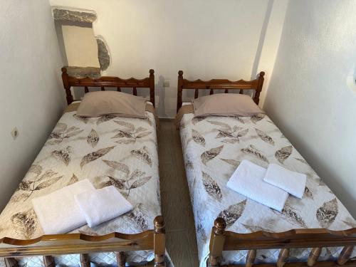 two beds sitting next to each other in a room at Katsi Traditional & Medieval House in Mesta