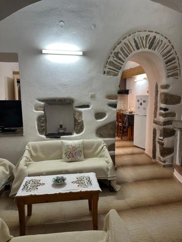 a living room with a couch and a table at Katsi Traditional & Medieval House in Mesta