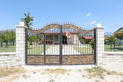 a gate to a park with a playground at Guest House MICAJ in Himare