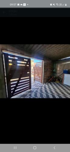 an open door to a room with a checkered floor at Sergio in Mongaguá