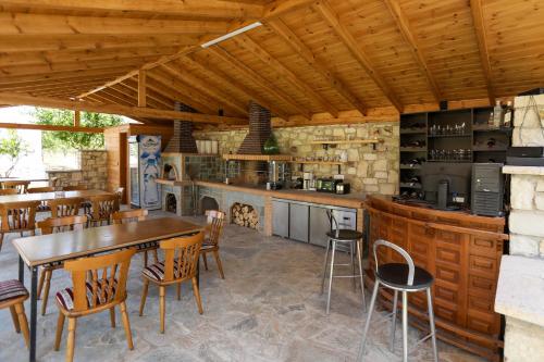 a kitchen and dining room with a table and chairs at Guest House MICAJ in Himare