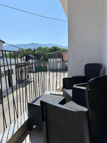 a group of chairs and tables on a balcony at Una La Unica in Bihać