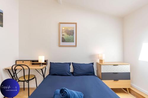 a bedroom with a blue bed and a desk at La Chrysalide by CozyLife - Centre Ville in Niort