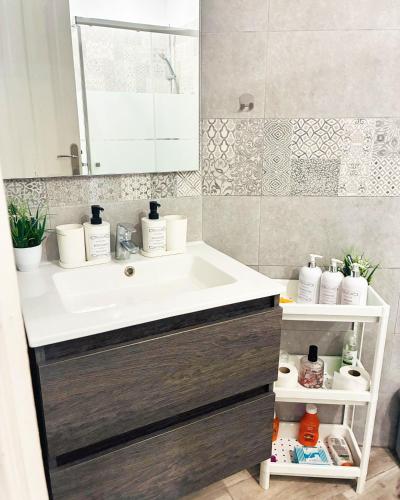 a bathroom with a sink and a mirror at Sissy Tenerife Apartman in San Miguel de Abona