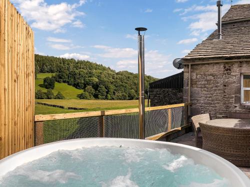 a jacuzzi tub on a balcony with a view at The Shippon in Appletreewick