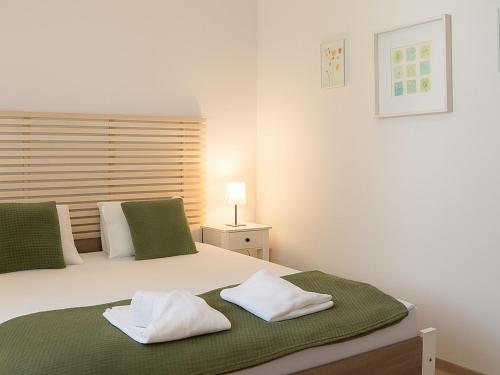 a bedroom with a bed with two pillows on it at Cosy Hideaway near Kiserdo in Balatonfüred