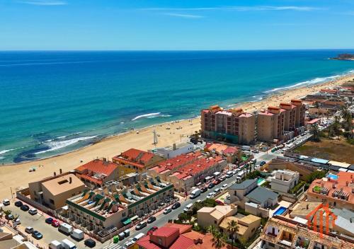 an aerial view of a beach with buildings and cars at Bungalow Oaxaca Playa de La Mata in Torrevieja